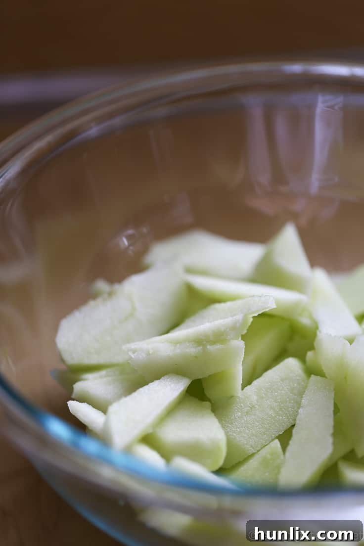 Caramelized Apple Inverted Delight 4 Apple Upside Down Cake ingredients – fresh Granny Smith apples being prepared for the sweet and spicy topping, ensuring a firm, tart base for the dessert.