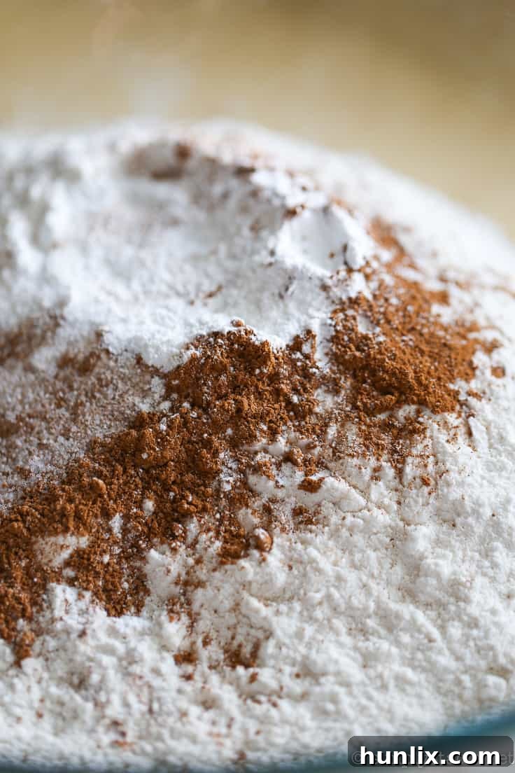 Caramelized Apple Inverted Delight 9 Mixing dry ingredients for Apple Upside Down Cake, including flour, cinnamon, nutmeg, salt, and baking powder.