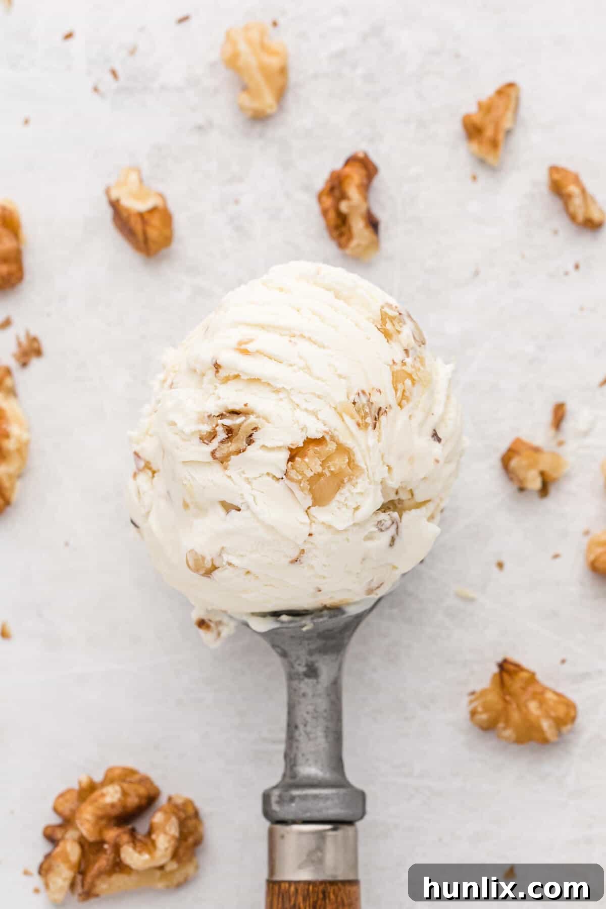 Maple walnut ice cream in an ice cream scoop.