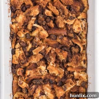 The Cinnamon Raisin Breakfast Casserole in a white casserole pan, ready to eat.