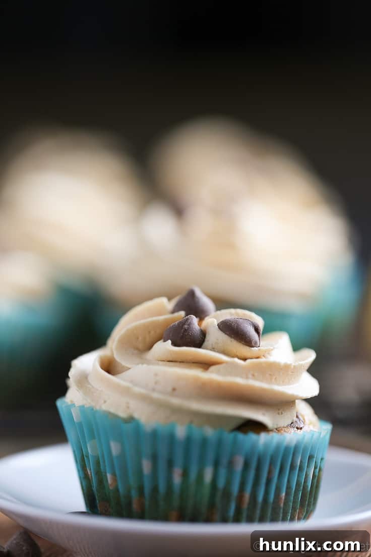 Close-up of a Banana Chocolate Chip Cupcake with Peanut Butter Frosting, adorned with extra chocolate chips