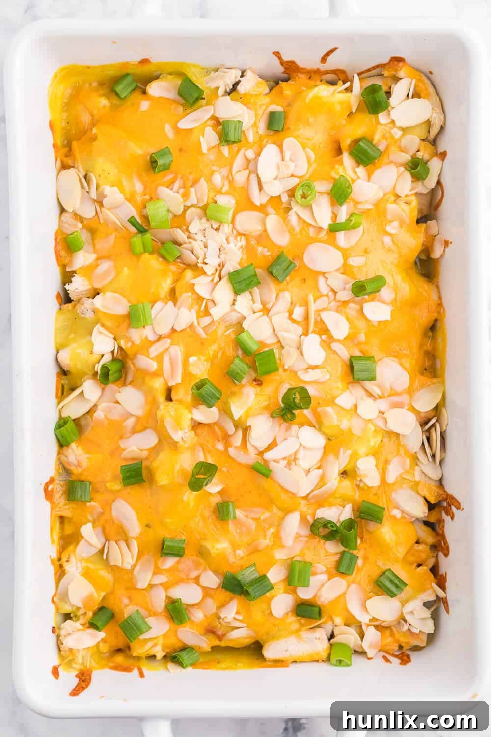 Creamy Chicken Asparagus Bake, loaded with tender chicken, fresh asparagus, a rich curry sauce, and topped with melted cheese and crunchy almonds. A perfect family casserole.