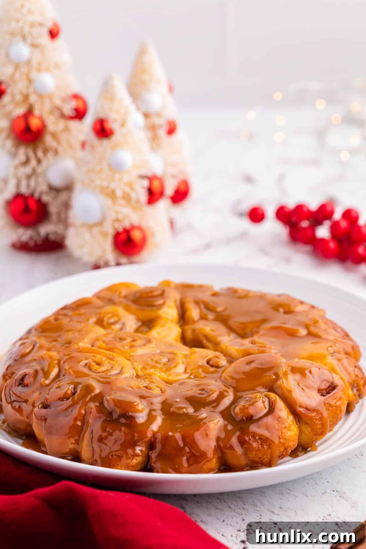 Rum-Kissed Mini Cinnamon Swirls 2 A plate of golden brown Mini Rum Butter Cinnamon Rolls drizzled with rum butter sauce, ready to be served.