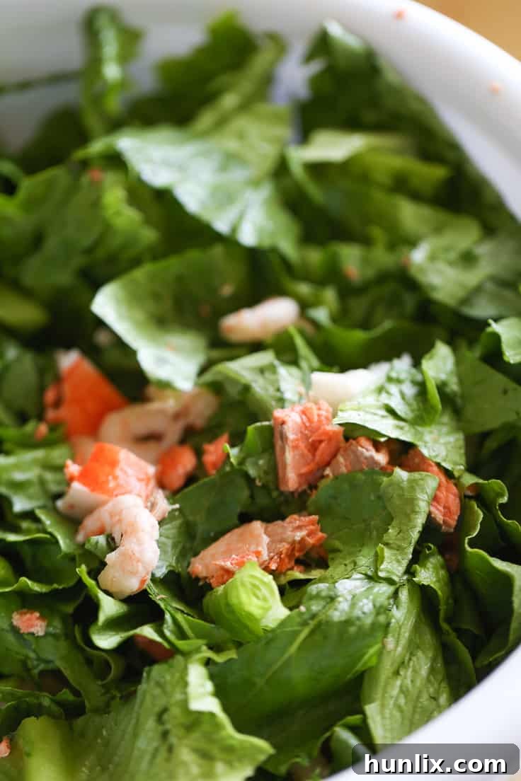 Torn Romaine lettuce in a large mixing bowl.