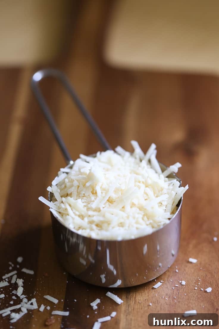 Freshly grated Parmesan cheese, a key ingredient for authentic Caesar flavor.