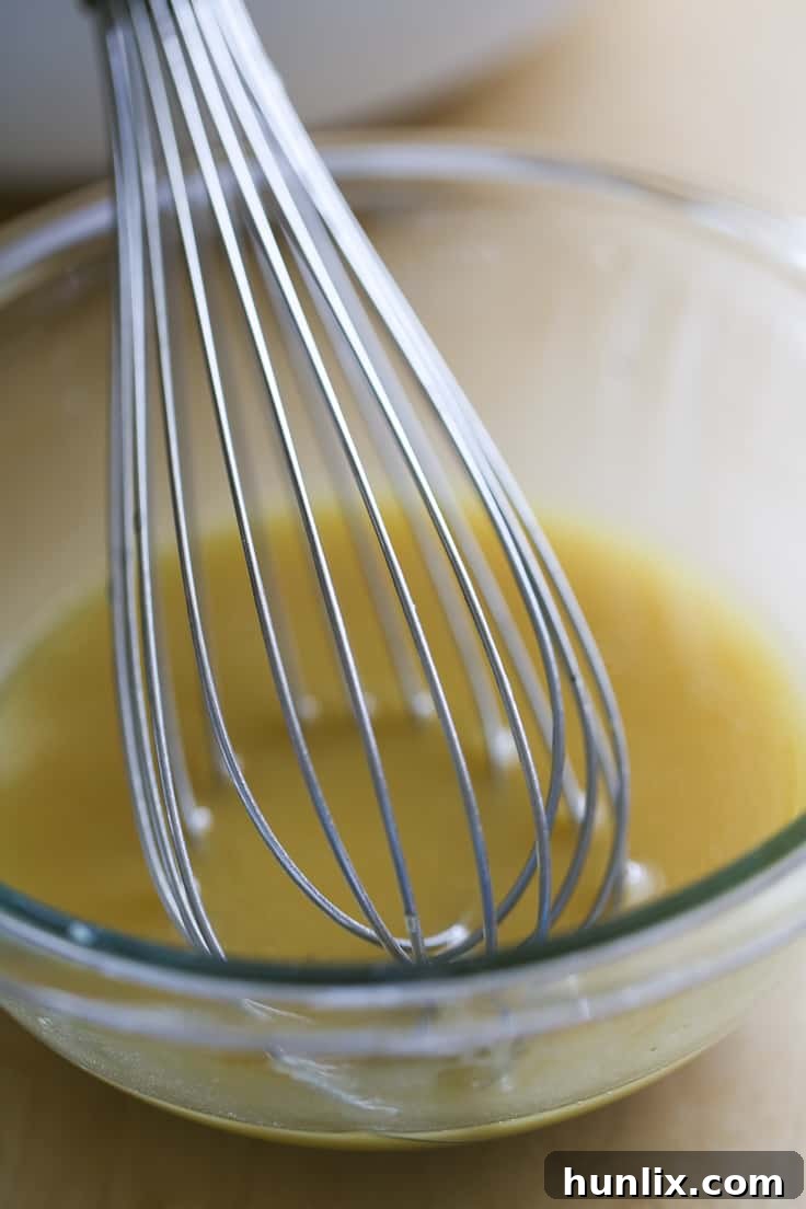 Ingredients for a homemade, egg-yolk-free Caesar dressing: olive oil, lemon juice, Dijon mustard, garlic, and Worcestershire sauce.