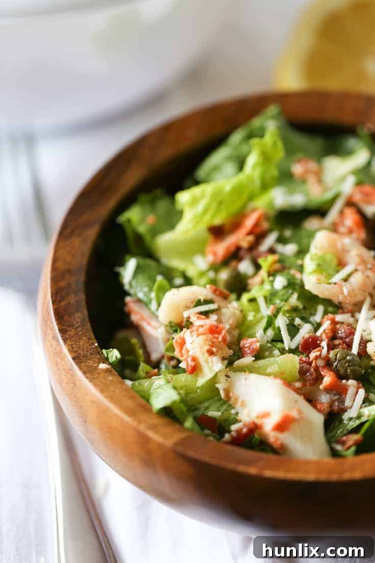 Close-up of the Seafood Caesar Salad, showcasing the diverse ingredients and rich dressing.
