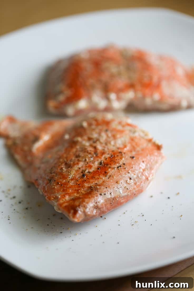 Pan-frying Sockeye Salmon fillets in olive oil until golden and flaky.