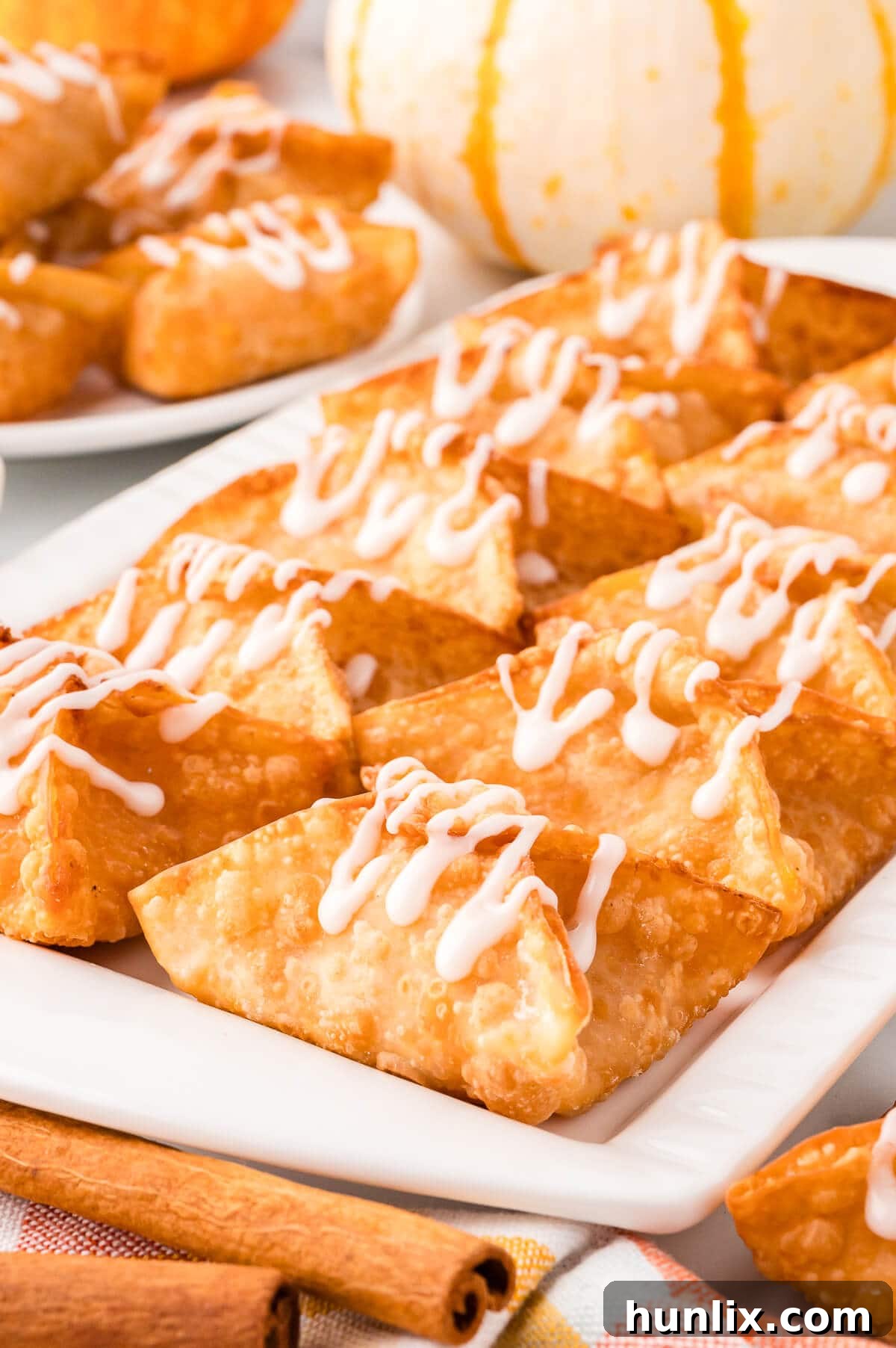 Maple-Kissed Pumpkin Cream Cheese Parcels 8 A beautifully arranged platter of pumpkin cream cheese wontons, perfectly golden and ready to be served.