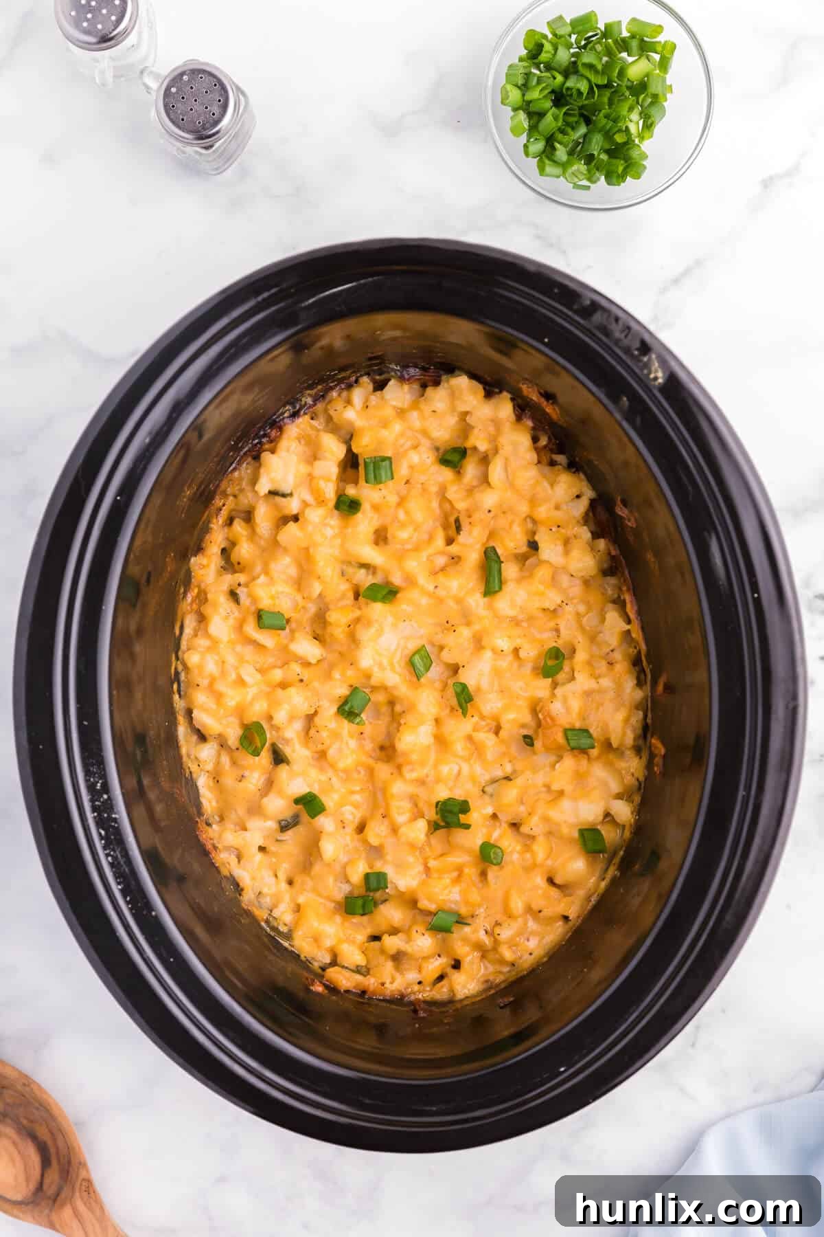 Slow Cooker Cheesy Potatoes - The creamiest potato recipe! Grab your Crockpot for this 4-ingredient side dish with frozen hash browns, cheese soup, and evaporated milk.