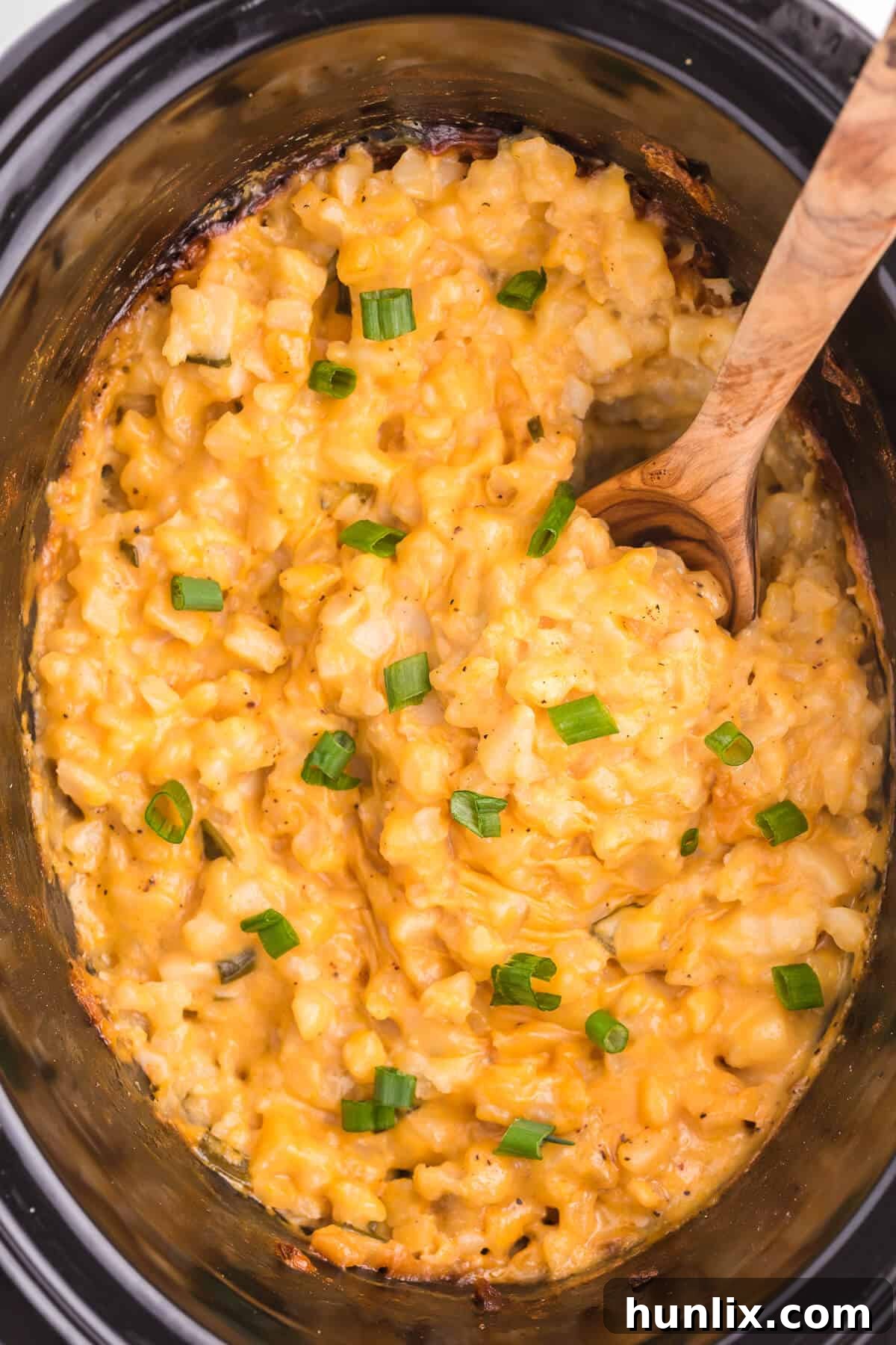 Slow Cooker Cheesy Potatoes - The creamiest potato recipe! Grab your Crockpot for this 4-ingredient side dish with frozen hash browns, cheese soup, and evaporated milk.