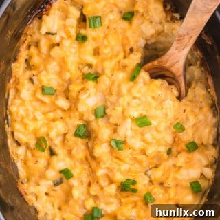 Slow Cooker Cheesy Potatoes is a delicious and hearty side dish to pair with your weeknight dinner. Frozen hash browns, canned cheese soup and a few other ingredients are all you need for this easy potato recipe.