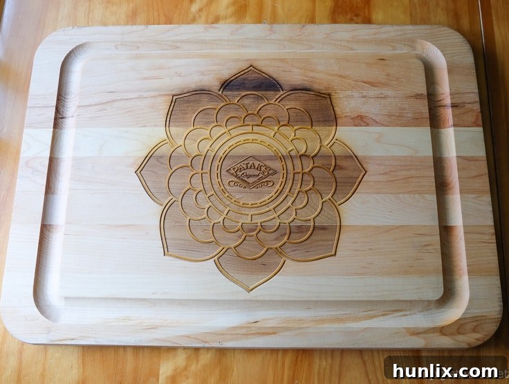 A close-up of a beautifully intricate Rangoli pattern crafted with colorful spices on a wooden cutting board.