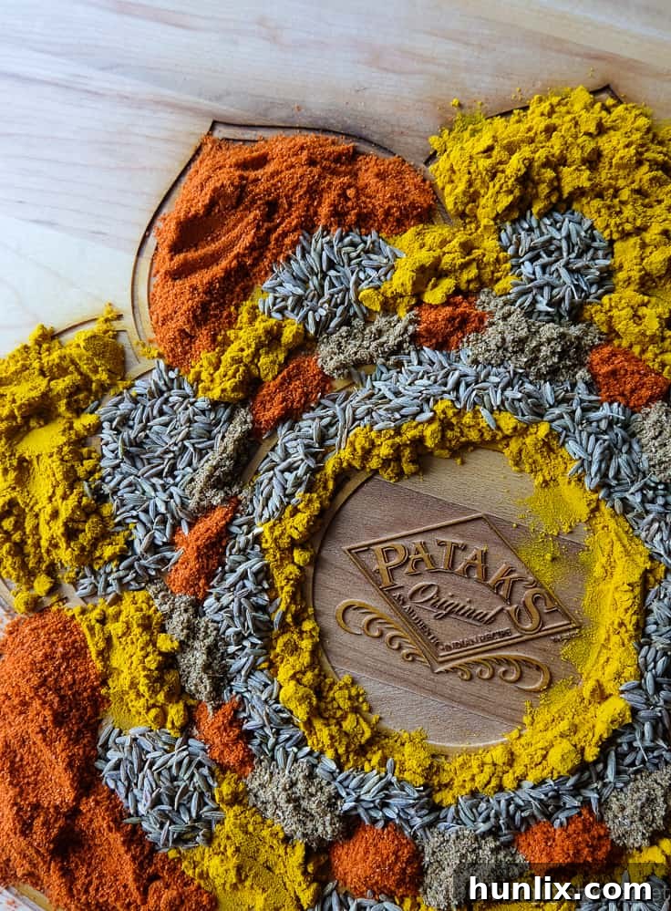 The completed handmade Rangoli pattern, a colorful spice art piece, displayed on a kitchen counter.