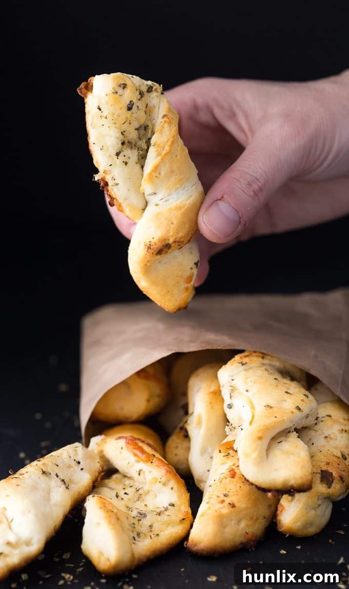Savory Garlic Swirls 2 Easy Garlic Twists: The ultimate quick garlic bread recipe using canned biscuits, butter, Italian seasoning, Parmesan, and mozzarella for a savory side dish.