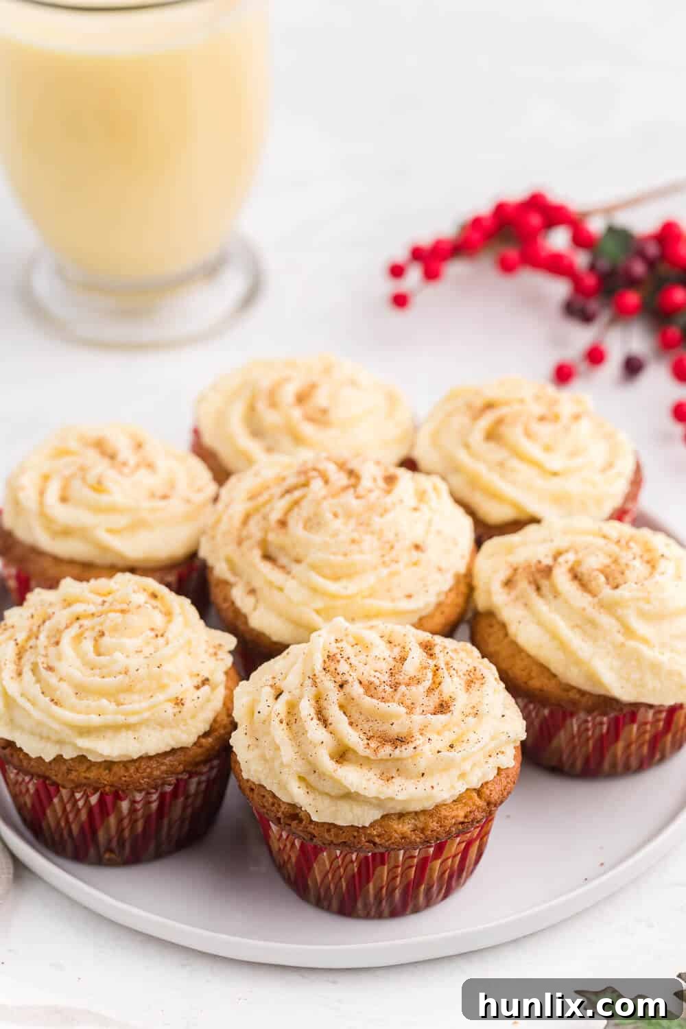 Festive Eggnog Cupcakes on a white plate, perfect for holiday celebrations