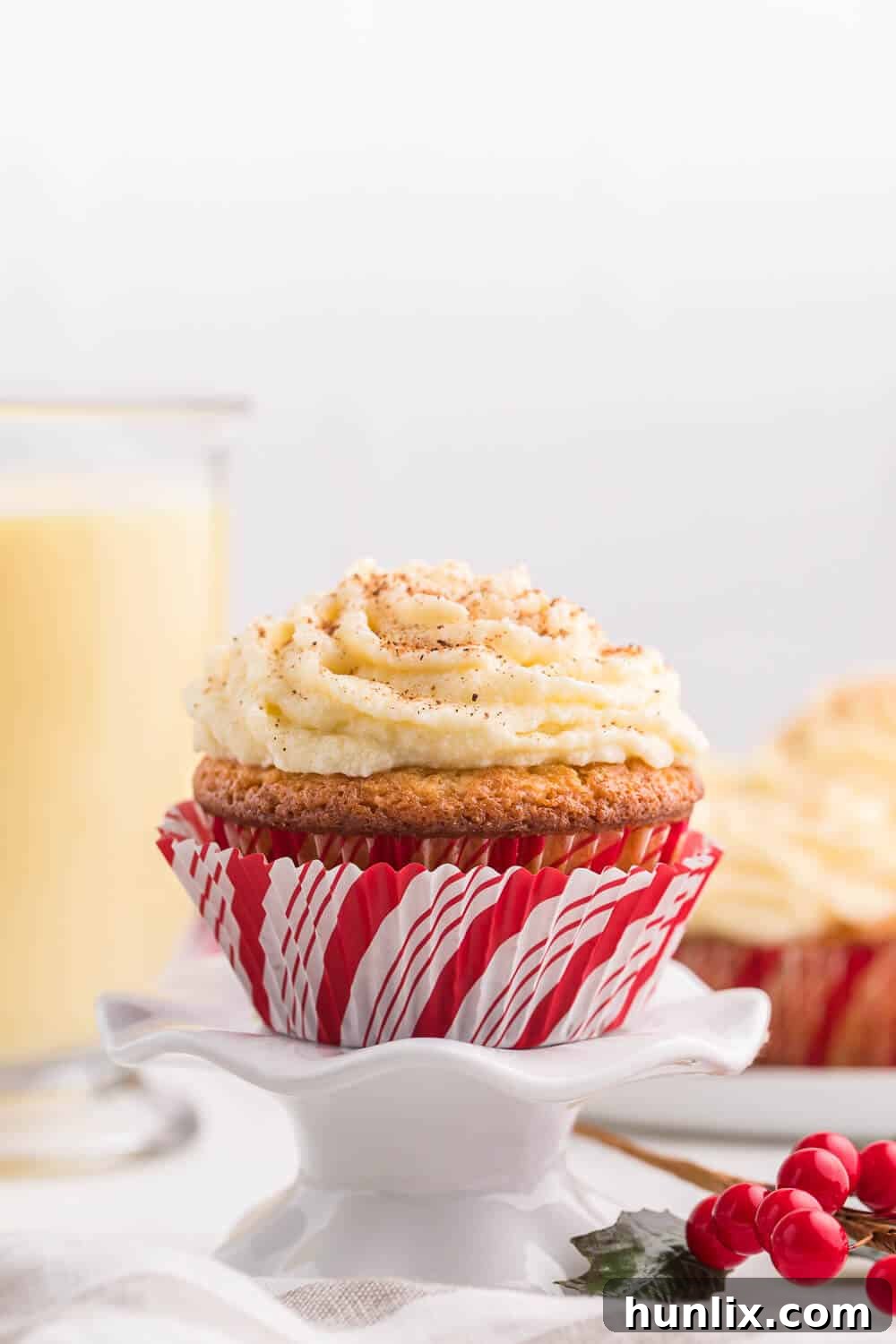 Side view of a perfectly frosted Eggnog Cupcake, highlighting its delicious layers