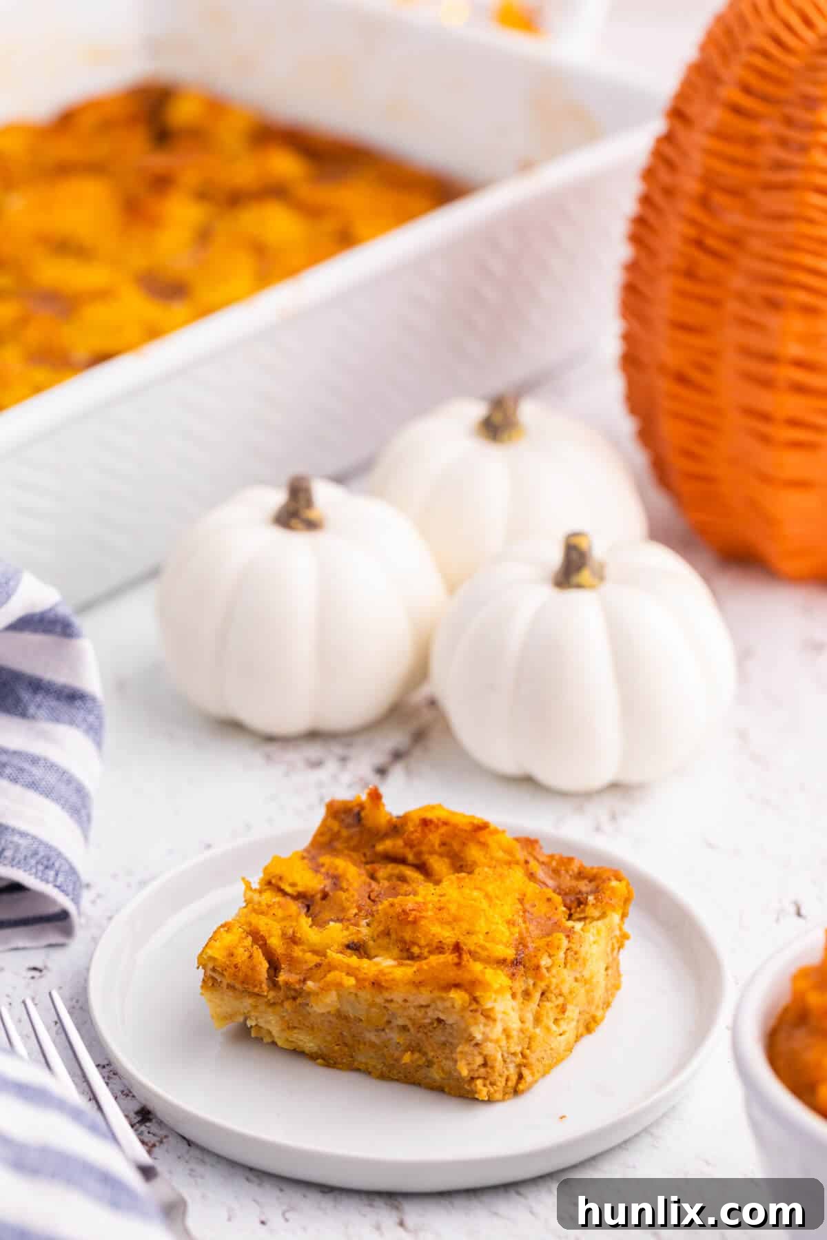 A plate with a slice of pumpkin gingerbread pudding.