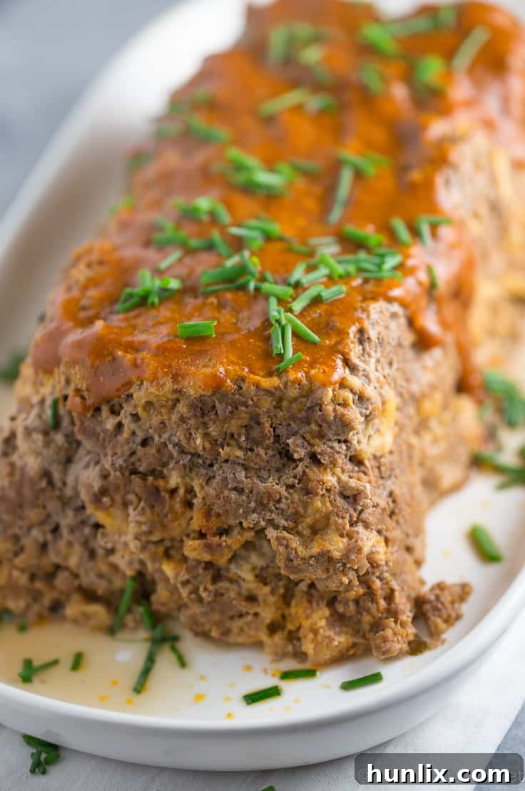 Masala Meatloaf 7 A large slice of Indian Meatloaf with a rich, savory topping.
