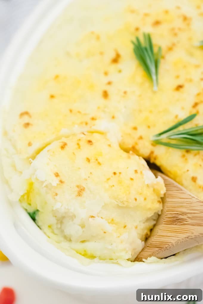 A wooden spoon in a casserole dish of the recipe.