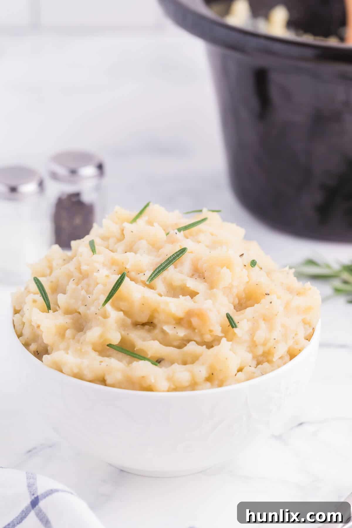Infused Slow Cooker Rosemary Garlic Mash 4 Slow Cooker Rosemary Garlic Mashed Potatoes - Make the creamiest mashed potatoes in your Crockpot! You'll love the rich, garlicky flavor in every bite for a delicious fall side dish.