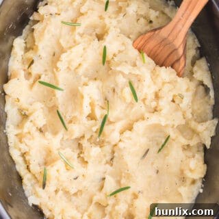 Slow Cooker Rosemary Garlic Mashed Potatoes are the best way to make potatoes. Creamy, rich, garlicky flavor in every bite.