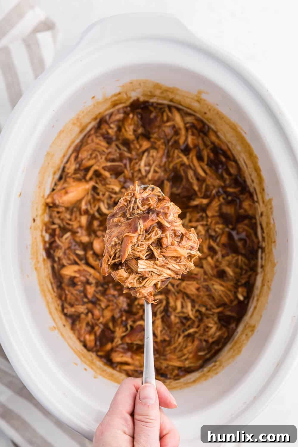 Cherry Coke Chicken in a slow cooker, featuring tender chicken breasts coated in a delicious cherry and barbecue sauce.
