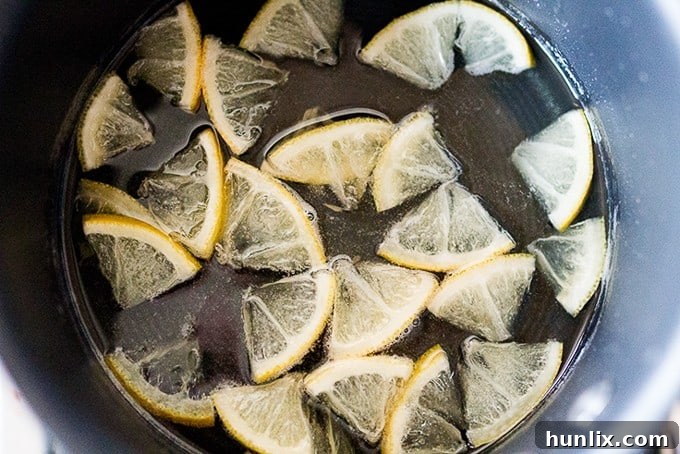 Close-up of a Lemon Drizzle Muffin showing its fluffy texture and glistening glaze.