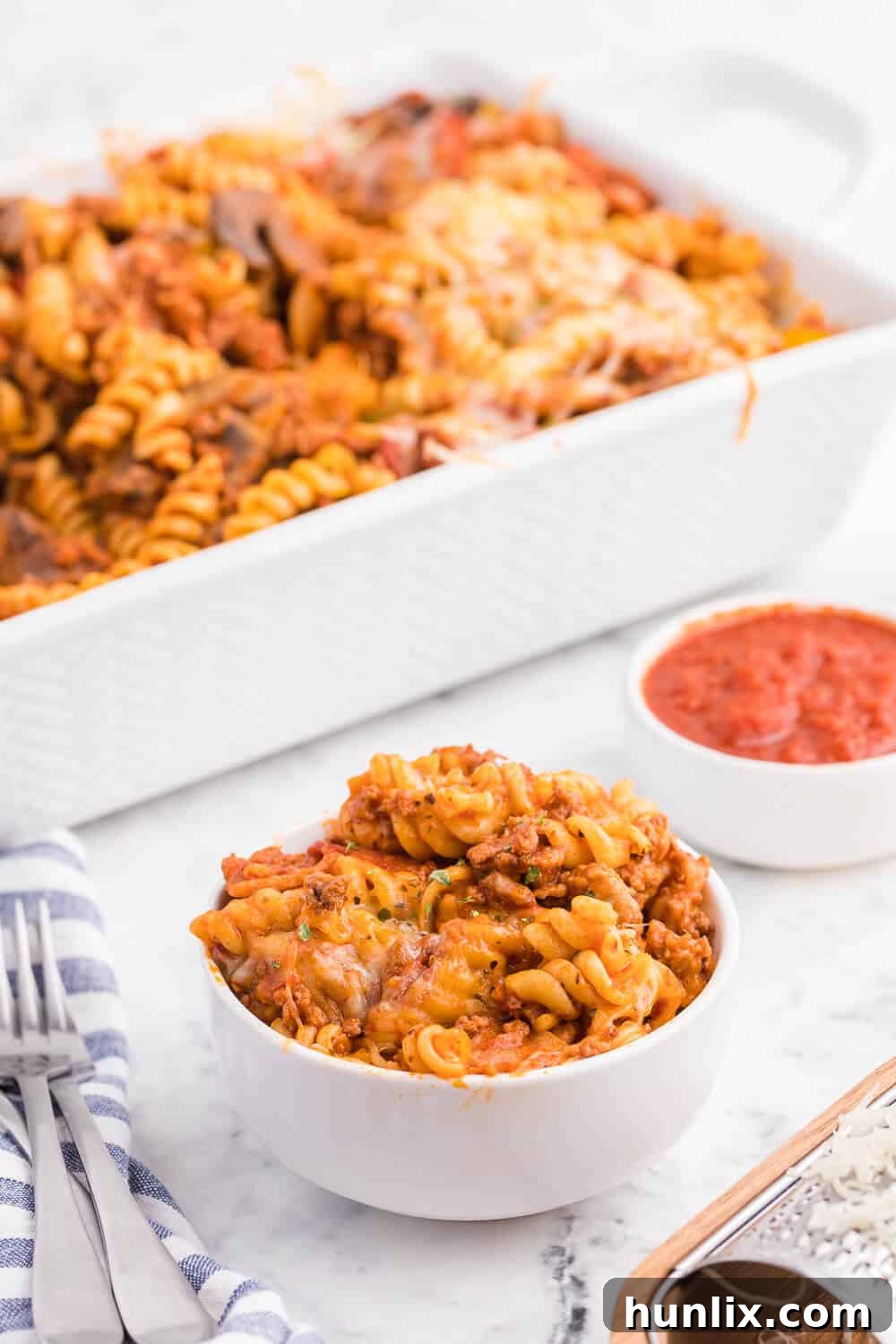 Meatzza Casserole - This crowd pleasing casserole recipe is packed with four kinds of meat, pizza sauce, veggies and oohey gooey cheese!