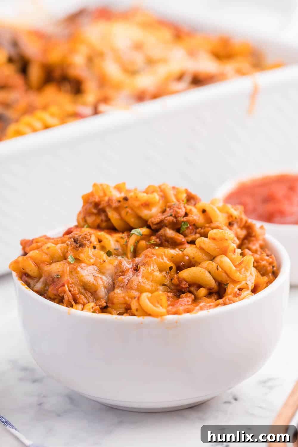 Meatzza Casserole - This crowd pleasing casserole recipe is packed with four kinds of meat, pizza sauce, veggies and oohey gooey cheese!