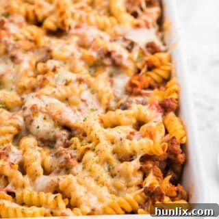 Meatzza Casserole - This crowd pleasing casserole recipe is packed with four kinds of meat, pizza sauce, veggies and oohey gooey cheese!