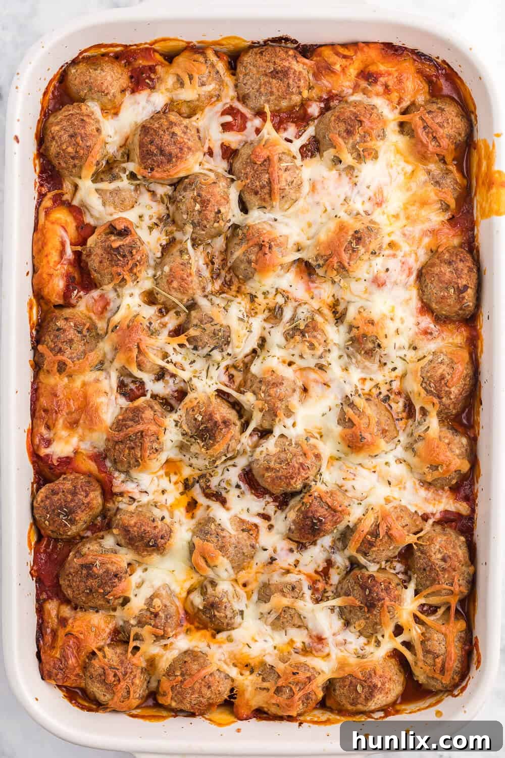 Delish Meatball Sub Casserole with melted mozzarella and Pillsbury biscuits