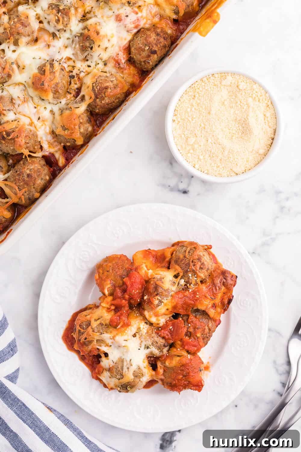 Serving of Meatball Sub Casserole with fresh herbs, showcasing its layers