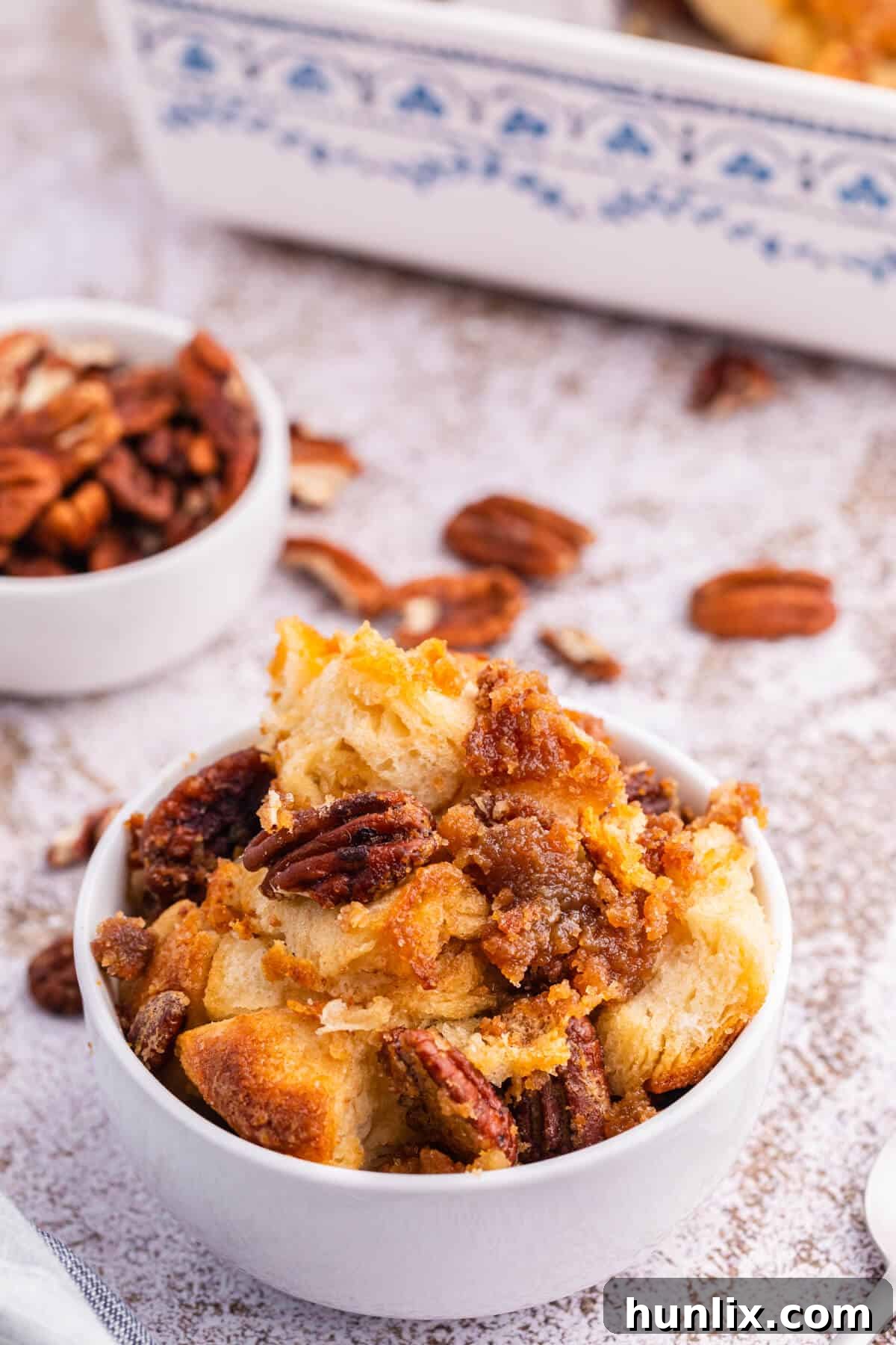 Pecan butter tart buns served in a white bowl, ready to be enjoyed.