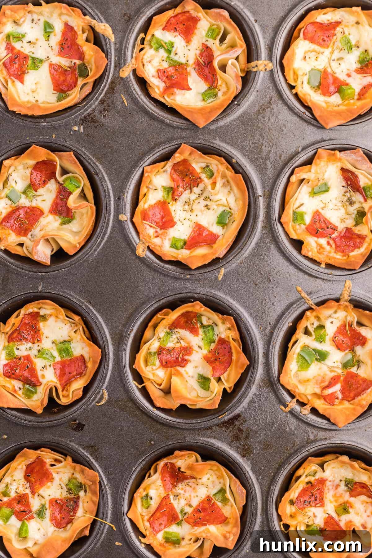 Pizza Wonton Cups Recipe - East meets West in this simple crunchy appetizer. A crispy wonton is filled with cheesy pizza goodness with any toppings you want!