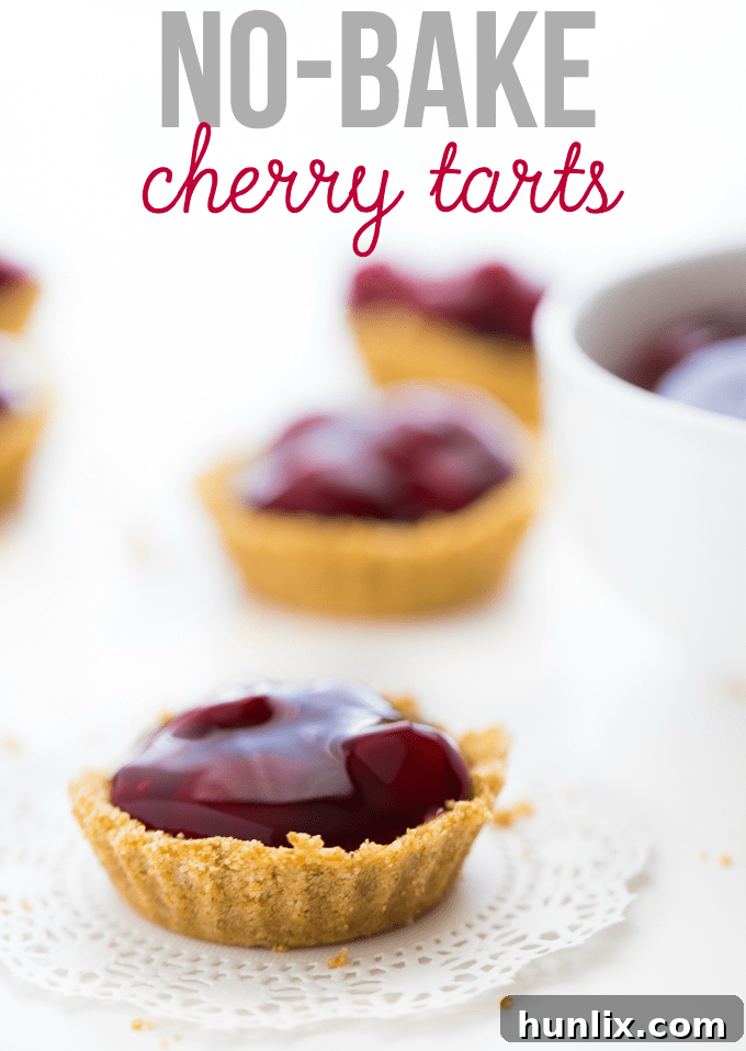 Effortless Cherry Tart Delights 3 A top-down view of six mini No-Bake Cherry Tarts arranged in a row. Each tart features a golden graham cracker crust overflowing with bright red cherry pie filling, with text overlay for a recipe.