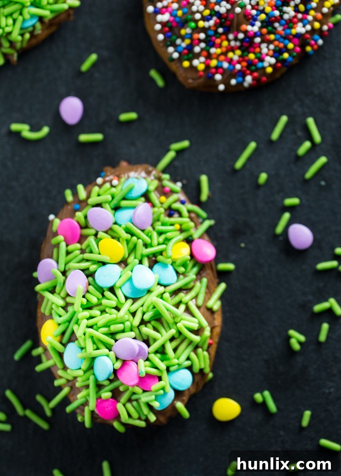 Super easy Easter dessert, Easter Egg Hand Pies, made with refrigerated pie crust, melted chocolate, and festive sprinkles. A perfect fun Easter recipe for kids to bake.