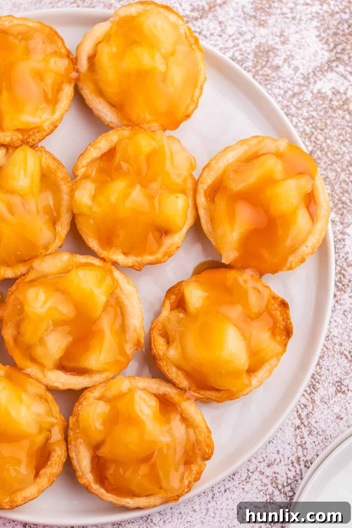 A close-up shot of a single caramel apple tart, ready to be eaten.