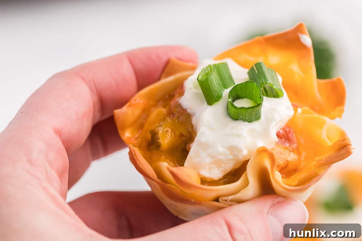 A vibrant selection of Taco Wonton Cups with various fresh toppings, showcasing the versatility and appeal of this easy party appetizer.