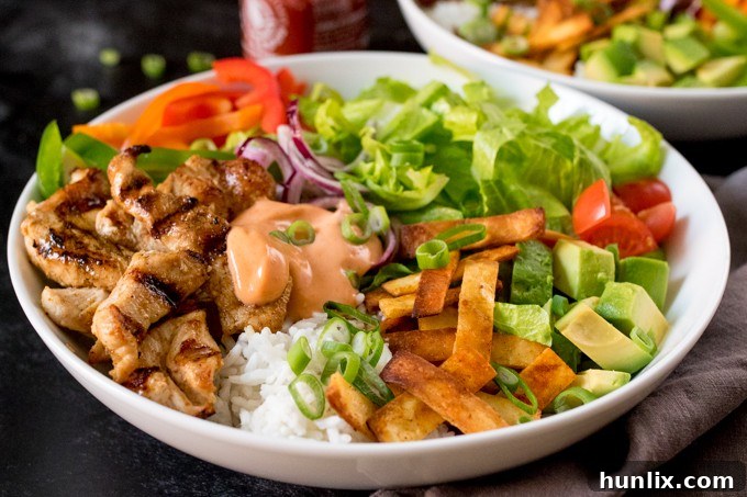 Southwest Fiesta Bowl 3 Close-up shot of a colorful Tex Mex Lunch Bowl on a dark surface, showcasing the fresh ingredients and chicken.