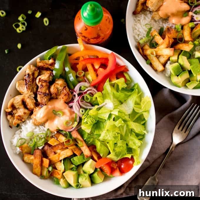 Southwest Fiesta Bowl 4 A Tex Mex Lunch Bowl artfully arranged on a dark surface, with a fork and napkin beside it, ready to be enjoyed.