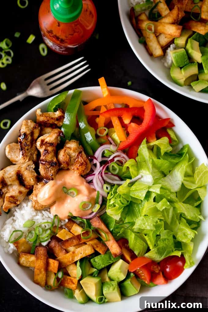 Southwest Fiesta Bowl 5 An overhead view of a Tex Mex Lunch Bowl on a sleek black surface, highlighting the vibrant ingredients.