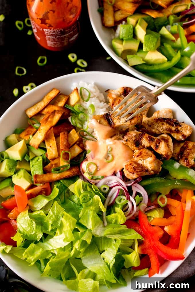 Southwest Fiesta Bowl 6 A close-up of a Tex Mex Lunch Bowl with a fork plunged in, highlighting the textures of the ingredients.