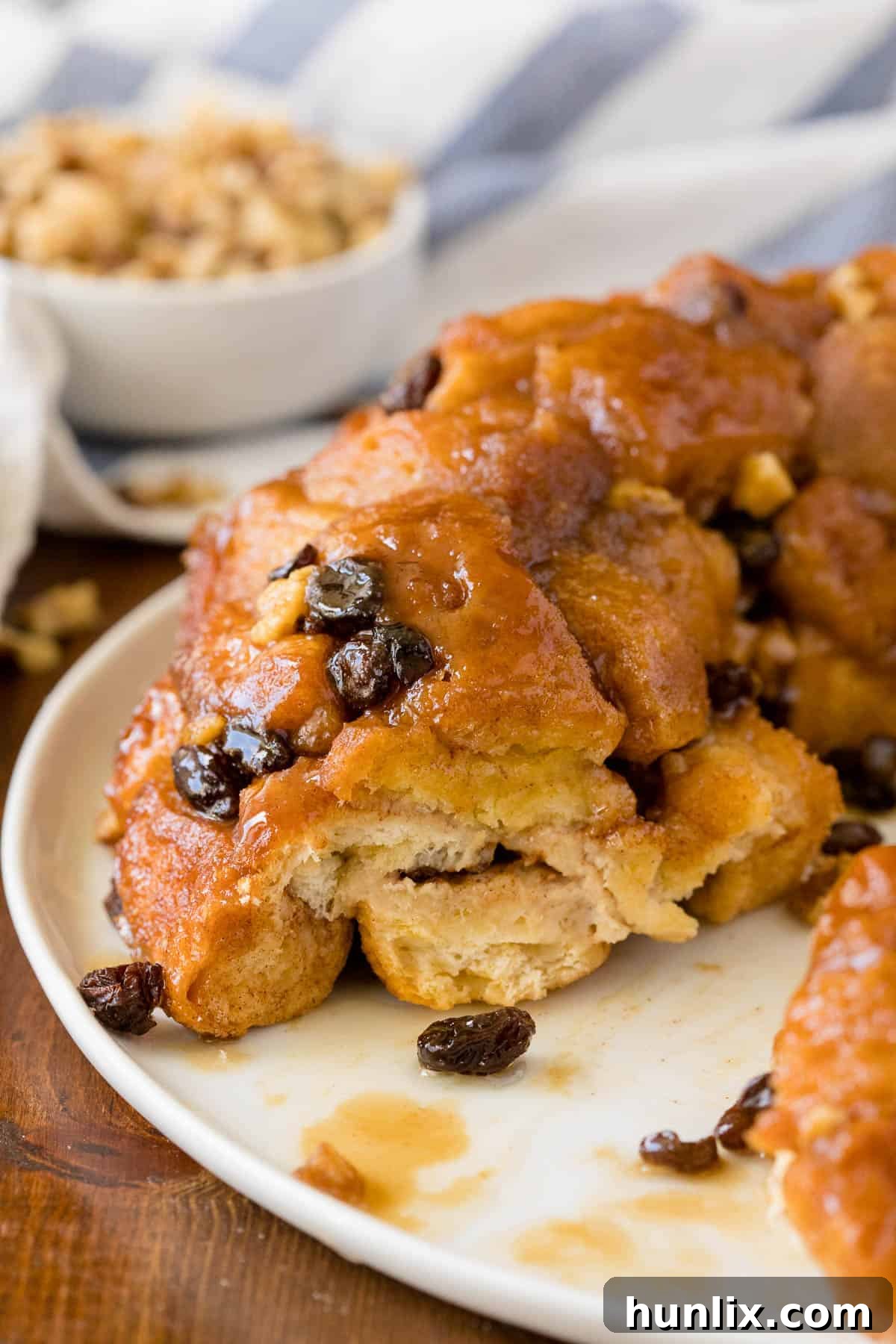 Caramel Cinnamon Monkey Bread 7 The recipe on a plate with a piece removed.