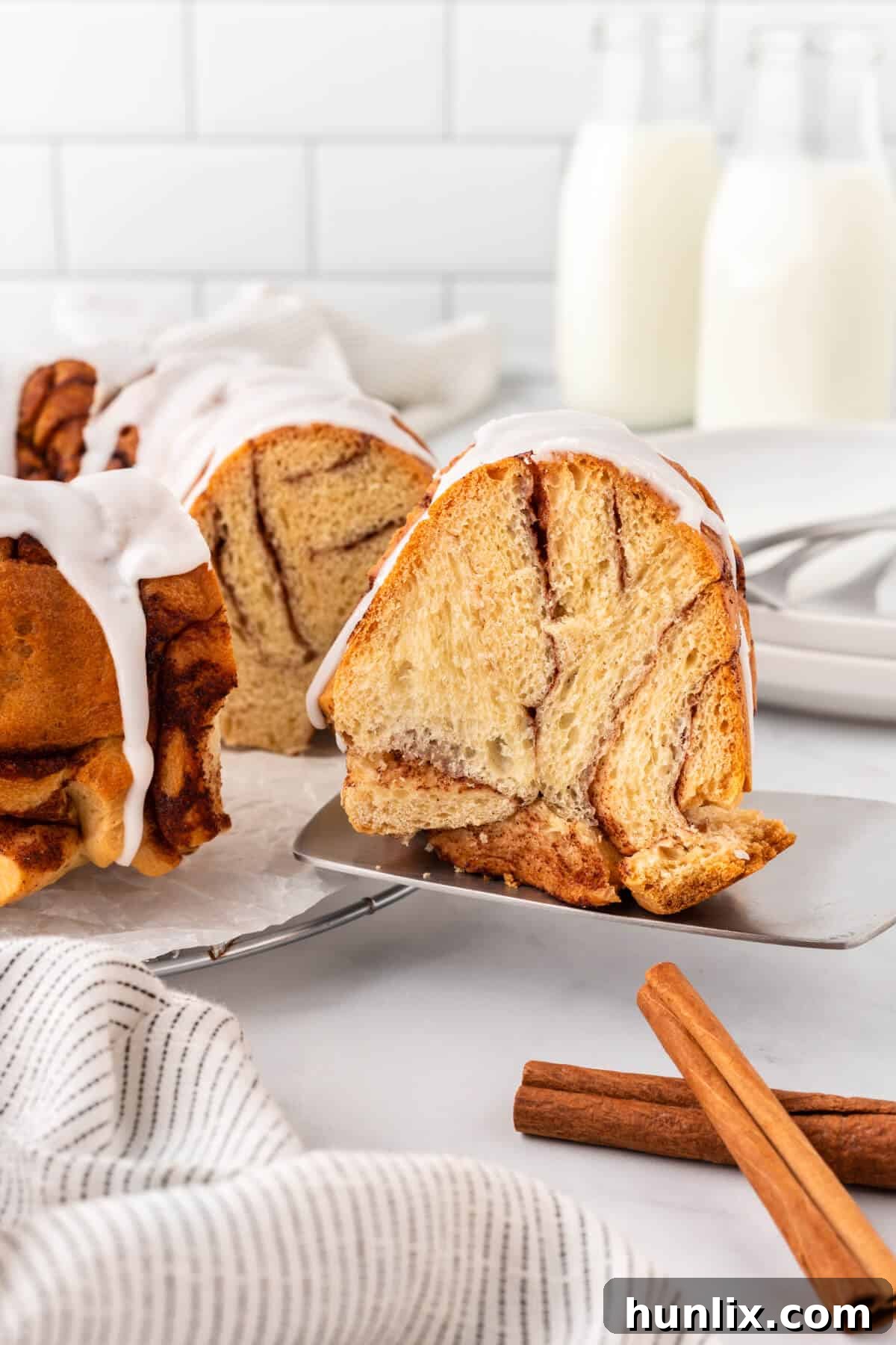 A slice of cinnamon roll monkey bread on a server.