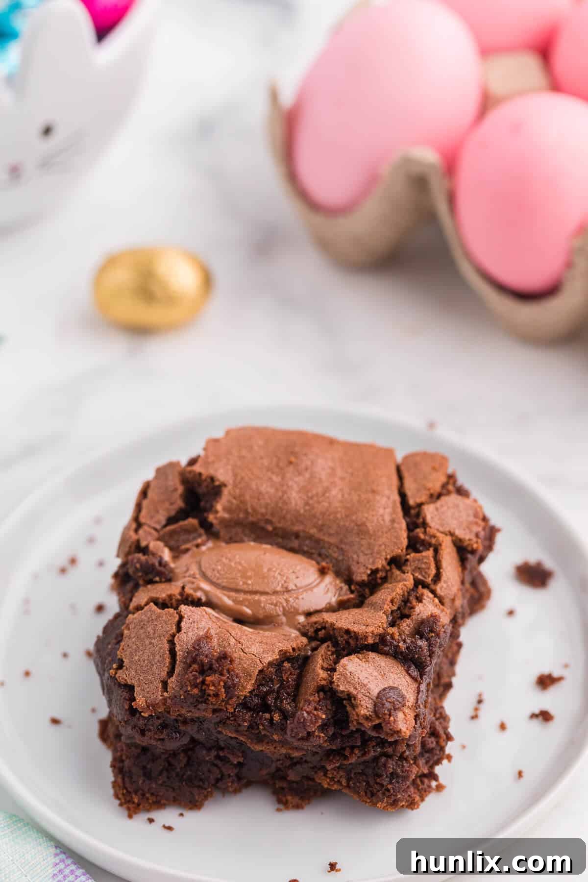 A single piece of Easter Egg Stuffed Brownie on a white plate, showcasing its gooey center.