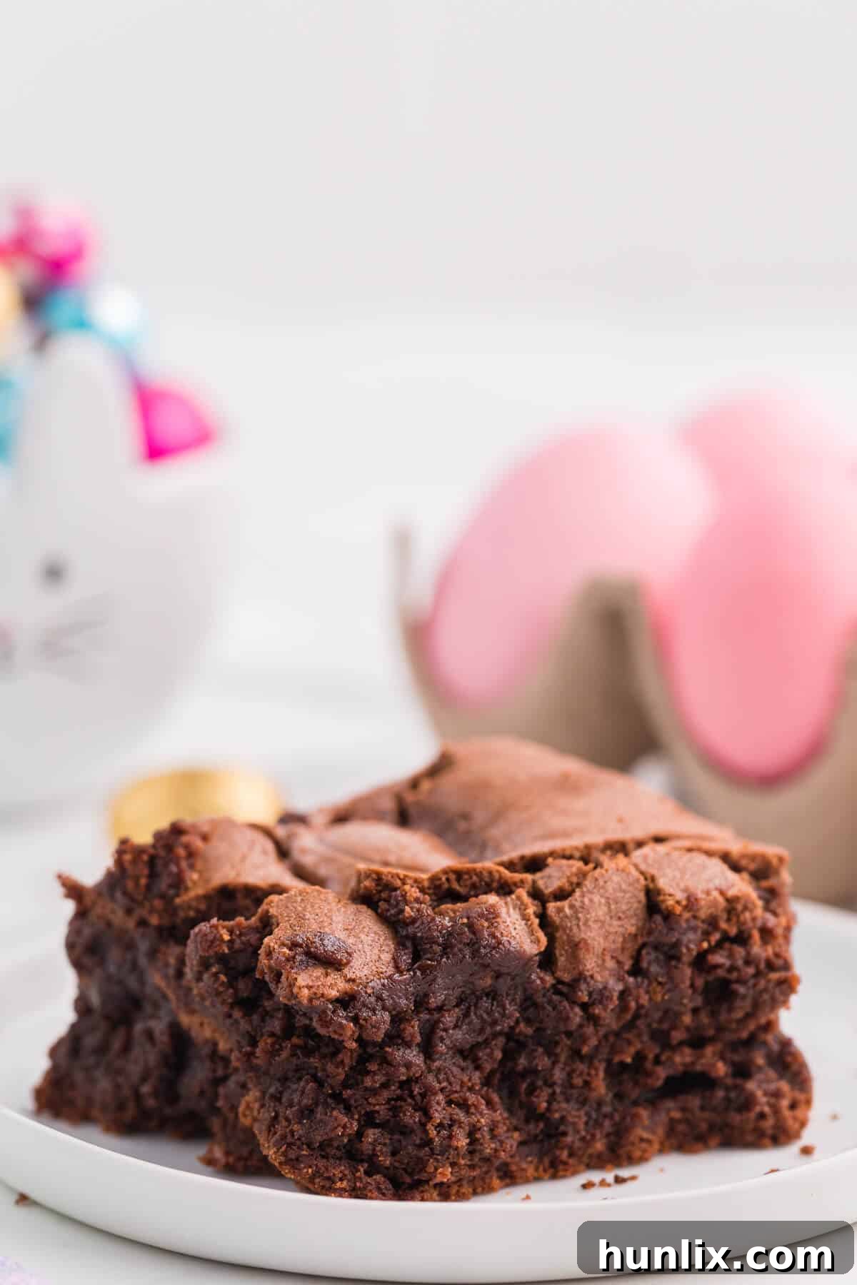 A slice of Easter Egg Stuffed Brownie on a plate, showing the melted chocolate egg inside.