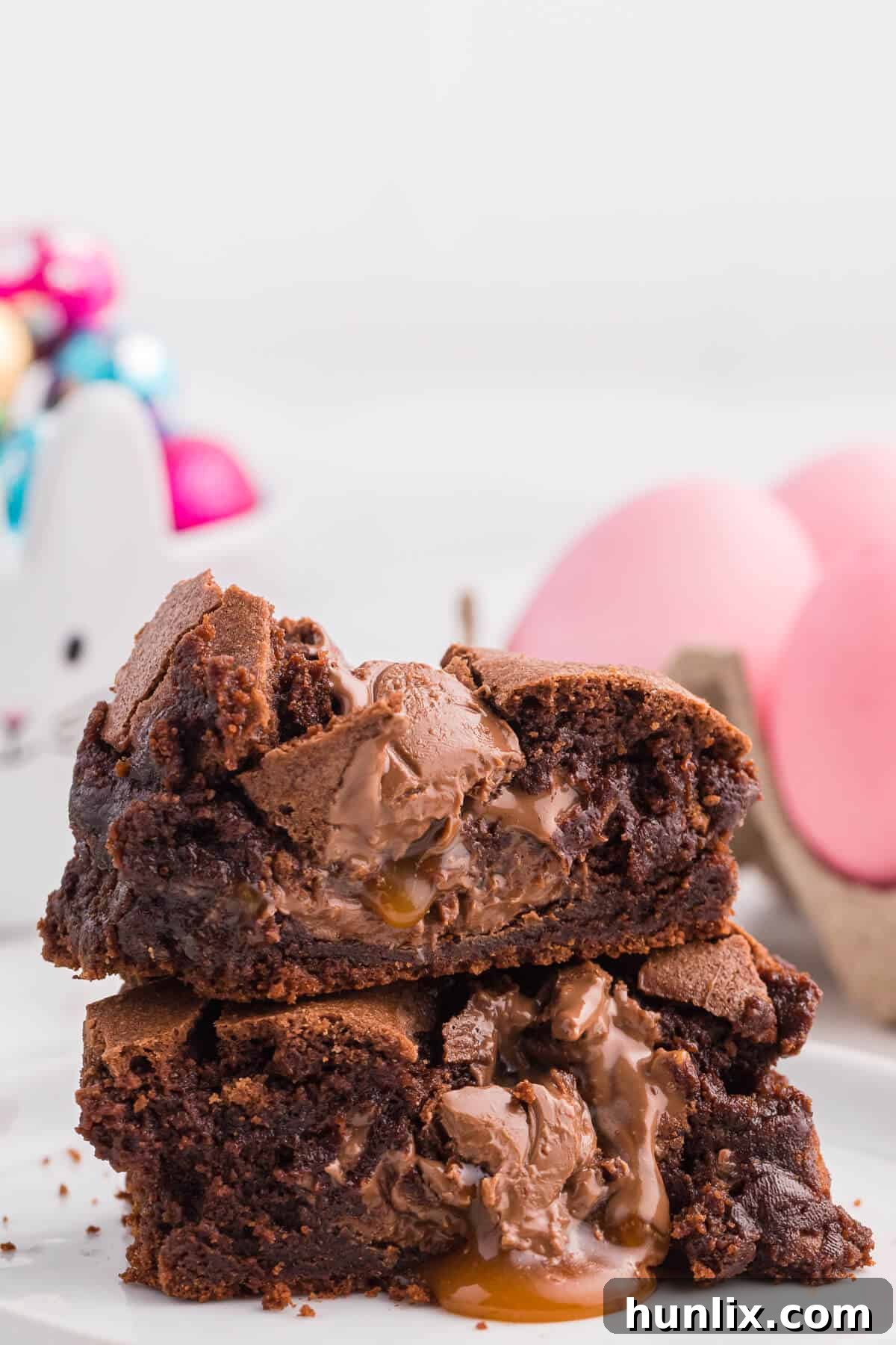 A stack of Easter Egg Stuffed Brownie halves, showing the melted centers.