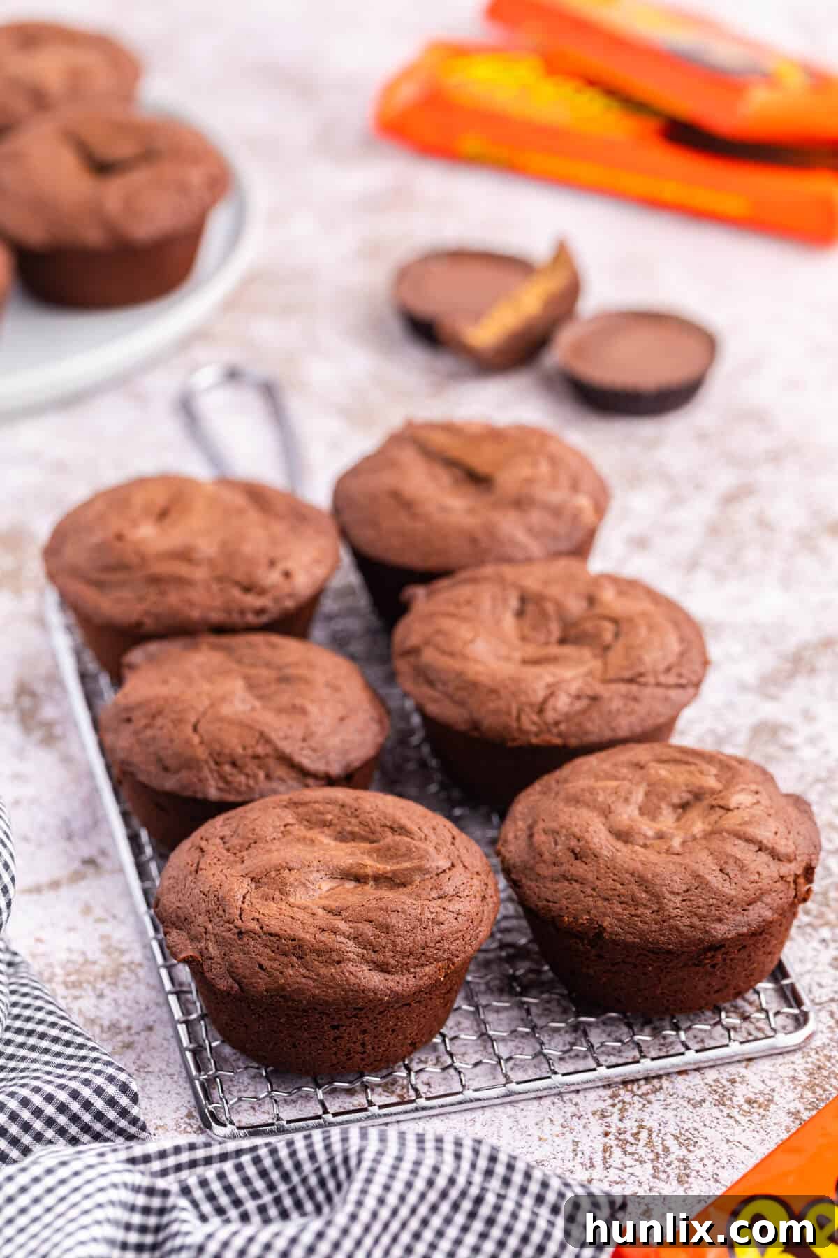Reese's Peanut Butter Filled Brownies 2 Delicious Reese's stuffed brownies cooling on a wire rack, showcasing their rich chocolate color and inviting texture.