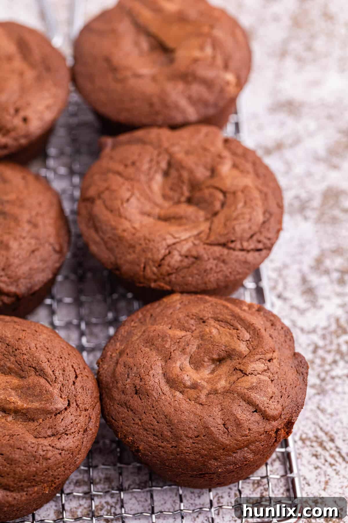 Reese's Peanut Butter Filled Brownies 3 Reese's brownie cups neatly arranged on a cooling rack, showcasing their uniform size and golden-brown tops.